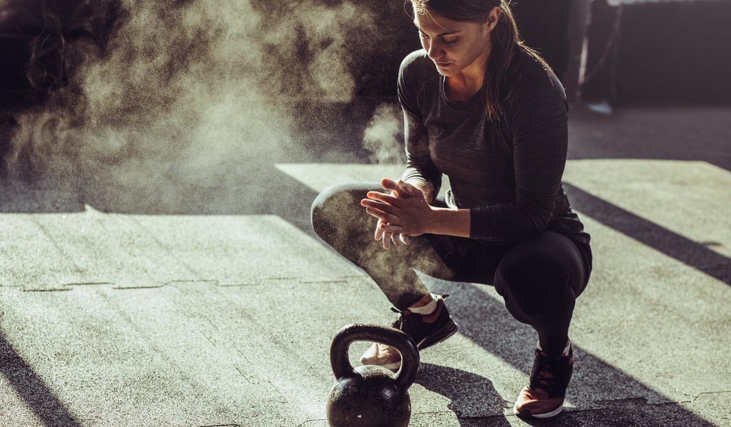 Young fit woman exercise with kettleball